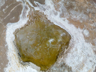 Close up aerial view of the green and partly frozen Laguna del Negro Francisco in the Atacama desert in Chile - Traveling and exploring South America