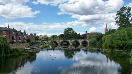 Fototapeta na wymiar Beautiful historical bridge in a countryside with river reflection.