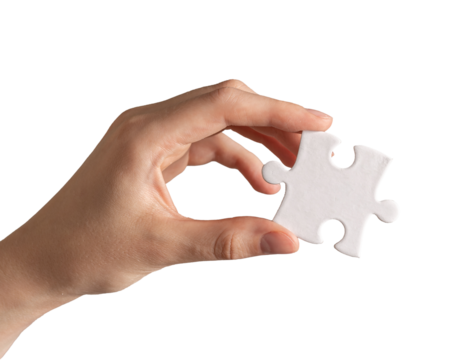 Hand holding single piece of puzzle isolated on white background