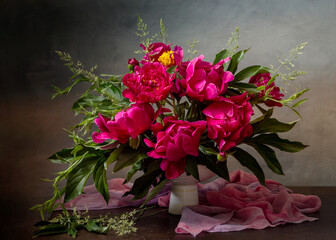 Still life with pink peonies on a dark background