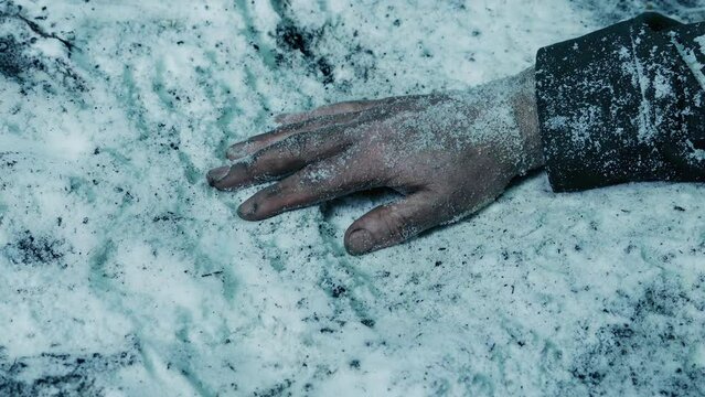 Person's Arm On The Snowy Ground