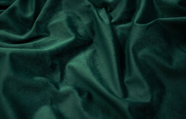 emerald velvet with folds background image, green shiny fabric silk for background web design...