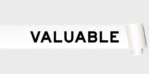 Ripped gray paper background that have word valuable under torn part