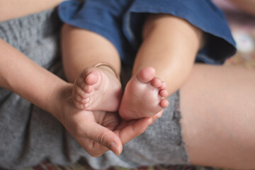 Mom holding infant foot