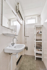 a small bathroom with a sink and towel rack in the corner, while it's not visible on the wall