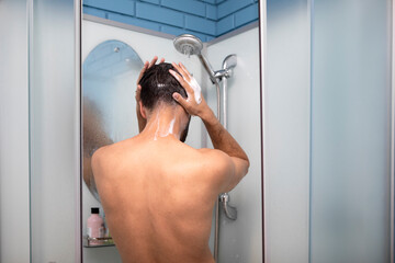 Man taking a shower in the bathroom at home