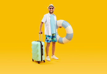 Full body photo of a funny young happy man tourist in rubber ring hurrying up on summer holiday trip in office clothes isolated on studio yellow background. Vacation and travel concept. - obrazy, fototapety, plakaty