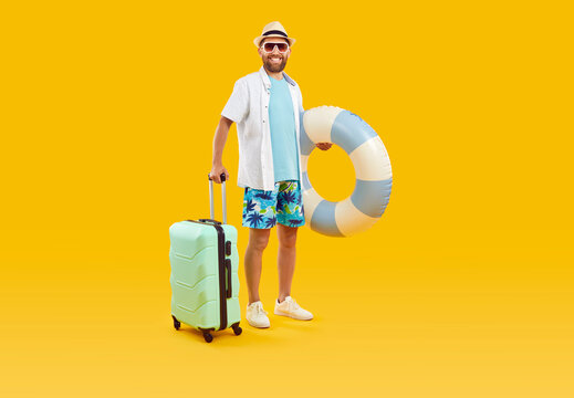 Full Body Photo Of A Funny Young Happy Man Tourist In Rubber Ring Hurrying Up On Summer Holiday Trip In Office Clothes Isolated On Studio Yellow Background. Vacation And Travel Concept.