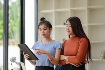 Two young freelance businesswoman discuss management planning. new startup project ideas planning and statistics and the investment market at the office