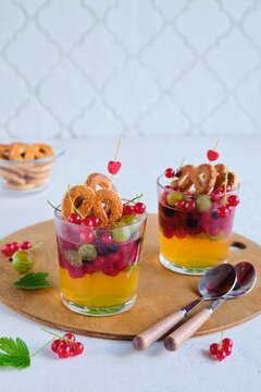 Dessert, jelly with summer berries and sugar cookies in a glass on a light concrete background. Desserts without baking. Children's desserts