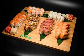 Large Philadelphia and California set Sushi Rolls with fresh fish, vegetables and cheese inside.