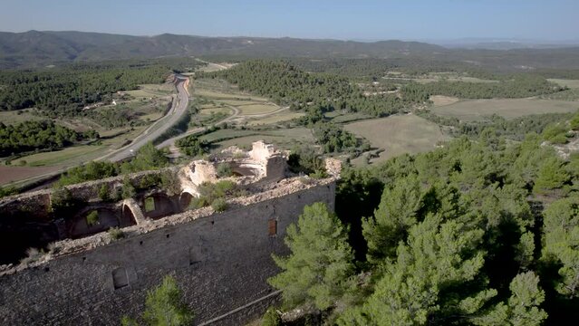 Lateral aerial view of the old destroyed ruins of Santa Barbara Church in Monroyo, Matarranya region, Spain