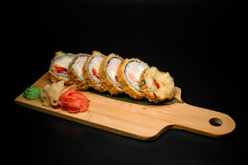 Hot tempura sushi with shrimp, vegetables and cheese in modern style
