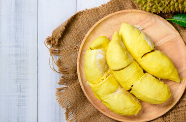 Top view of Durian fruit. Ripe monthong durian on wood plate and white wood background, king of fruit