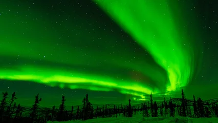  Image of a v-shaped aurora borealis or northern lights fanning out across the night sky in the mountains of Fairbanks, Alaska. © Patrick