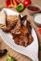 delicious Juicy shish kebab of lamb ribs cooked on fire, shish kebab on a white plate in a cafe. foodphoto