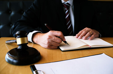 Legal counsel presents to the client a signed contract with gavel and legal law. justice and lawyer...