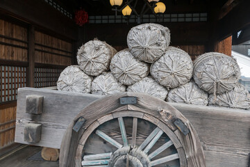 Rope bottle on rickshaw in front of Japanese wooden house