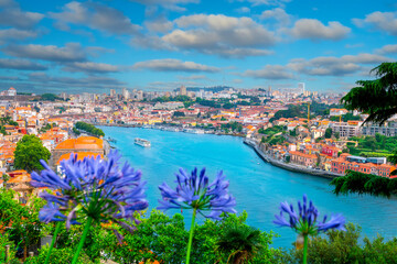 Panoramic top view of the famous landmark River Douro, traditional houses and the skyline of Porto City, in Portugal