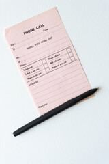 vintage pink phone call message slip with black ball point pen