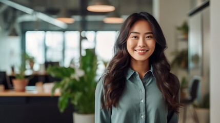 Portrait of happy asian woman smiling standing in modern office space. 