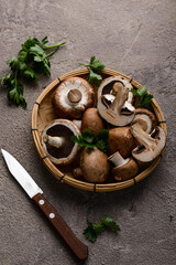 Raw champignon mushrooms on black background