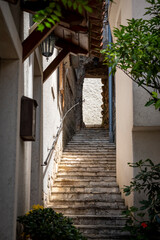 Fototapeta na wymiar Beautiful, narrow, stone staircase in the mediterranean town of Brsec, Croatia, located on the shore of istrian peninsula