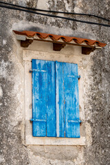 Beautiful, old and aged, wooden window shutters closed on the stone house at the small town of Brsec, Croatia on istrian peninsula coast