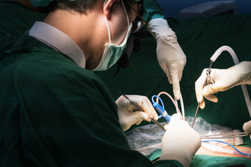 Medical team of surgeons in hospital working surgical intervention.Surgery operating room with...