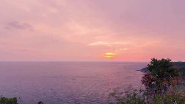 timelapse sunset on coastline tropical cliff with golden sea water surface with vanila sundown sky, nature sea ocean summer tropical sunset background at phromthep cape