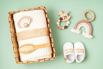 Gift basket with gender neutral baby garment and accessories. Care box of organic newborn clothes,...