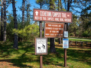 head trail sign with warning signs in state park