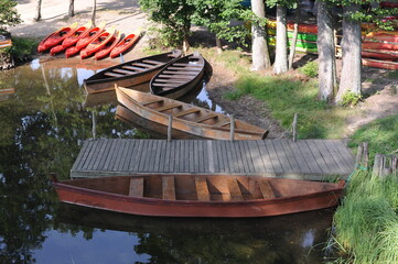 Beautiful summer landscape with river and wooden boats in the forest in summer