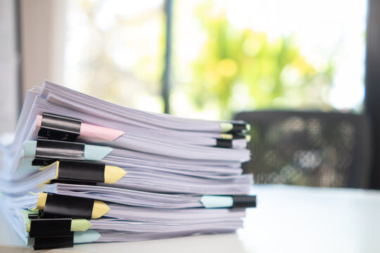 A huge stacked documents is an annual earnings summary document prepared for business people to use in attending meetings and this stacked paper is also an important document.