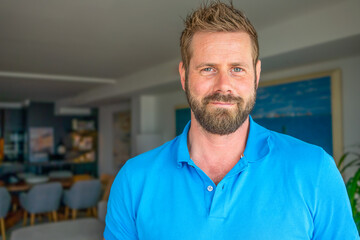 Fototapeta premium Close up headshot portrait of smiling 30s Caucasian man look at camera posing in own flat or apartment.