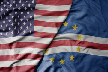 big waving colorful flag of united states of america and national flag of cape verde .