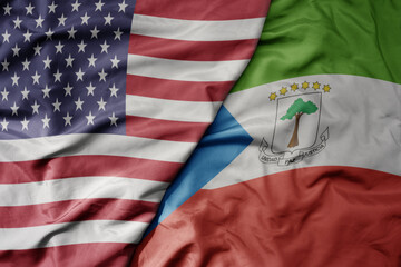 big waving colorful flag of united states of america and national flag of equatorial guinea .