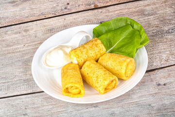 Stuffed pancakes with cream sauce