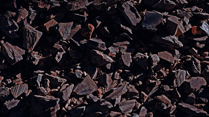 Stones rocks spiky close up structure illuminated by the sun, rock texture for background. Top view