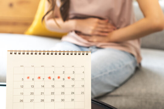 Menstruation, period cycle day of monthly, hurt asian young woman, female hand in stomach ache, suffer from PMS premenstrual, belly or abdomen pain on bed at home. Health problem Inflammation in body.