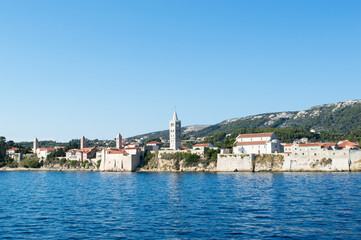 Fototapeta na wymiar Historic architecture in Rab town, Croatia, with four church towers, waterfront