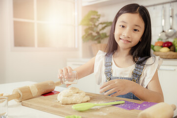 child girl portrait happy smiling playing cooking bakery food at home kitchen holiday activity