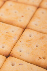 Delicious spicy square crackers closeup. Macro shot.
