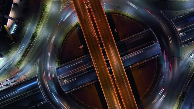 Hyperlapse time-lapse of car traffic transportation above circle roundabout road in Asian city. Drone aerial view fly in circle, high angle. Public transport or commuter city life concept	
