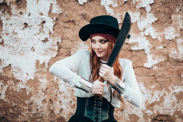 Outdoor portrait of young female in pirate costume with a machete - obrazy, fototapety, plakaty