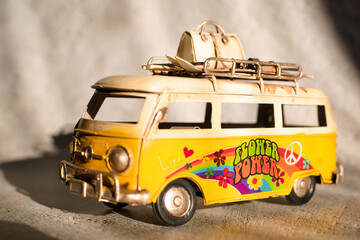 Small hippie yellow van toy. Vacation, traveling concept