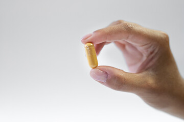 Dietary supplements capsule held in hand, healthy way of life, strengthening body and mind