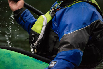 close up of kayaker on the water and the gear they are wearing