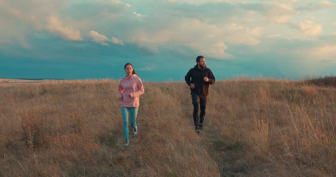 active ambitious couple going jogging in the countryside Motivation Challenge Slow motion, family goes in for sport, health and body care Leisure Free spare time, Soft focus Wellness