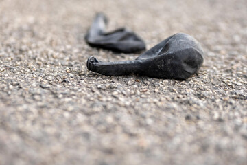 old black balloons on a street